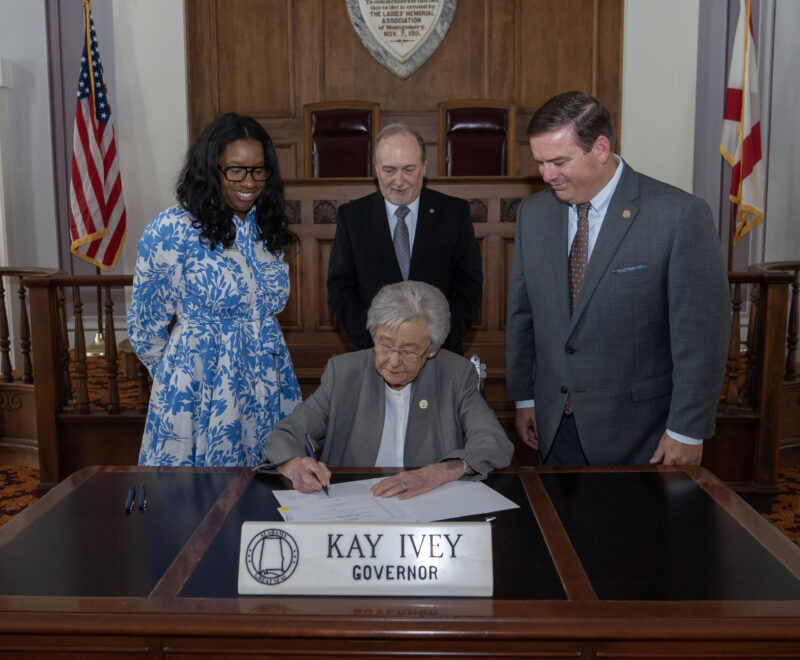 Gov. Ivey signing HB266 accompanied by ACCS Communications and Public Relations Coordinator for Adult Education, Letrice Ware; Vice Chancellor of Adult Education and Correctional Education, David Walters; and Alabama House Representative Matt Woods.