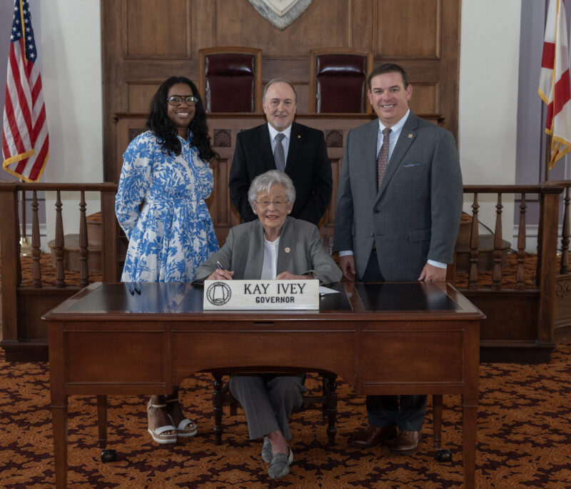 Gov. Ivey signing HB266 accompanied by ACCS Communications and Public Relations Coordinator for Adult Education, Letrice Ware; Vice Chancellor of Adult Education and Correctional Education, David Walters; and Alabama House Representative Matt Woods.